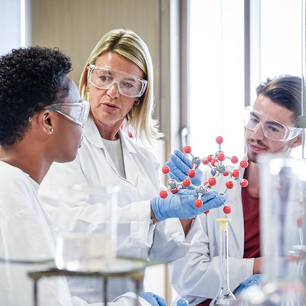 A medical sciences graduate program students talks with her professor in a stairwell.