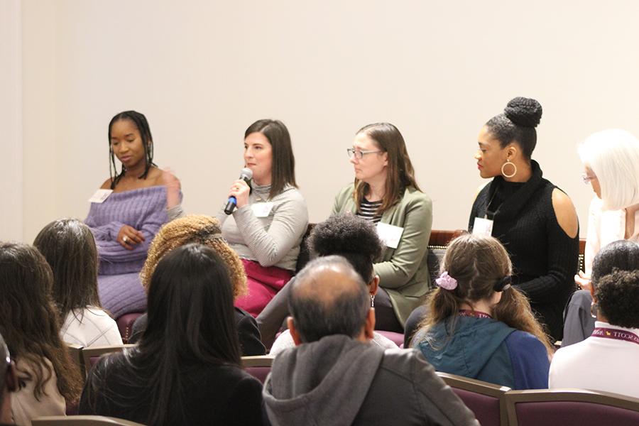 Four Agnes Scott alums with microphones speak in a panel.