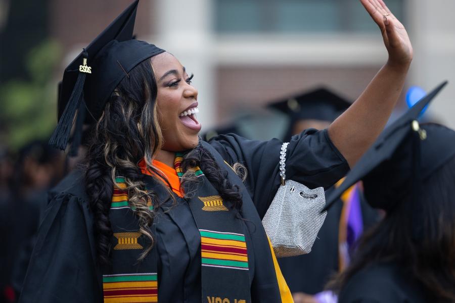 A student waves to a family member off camera