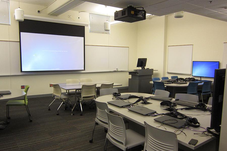 View of Campbell G27 showing desks with laptops and projection screen