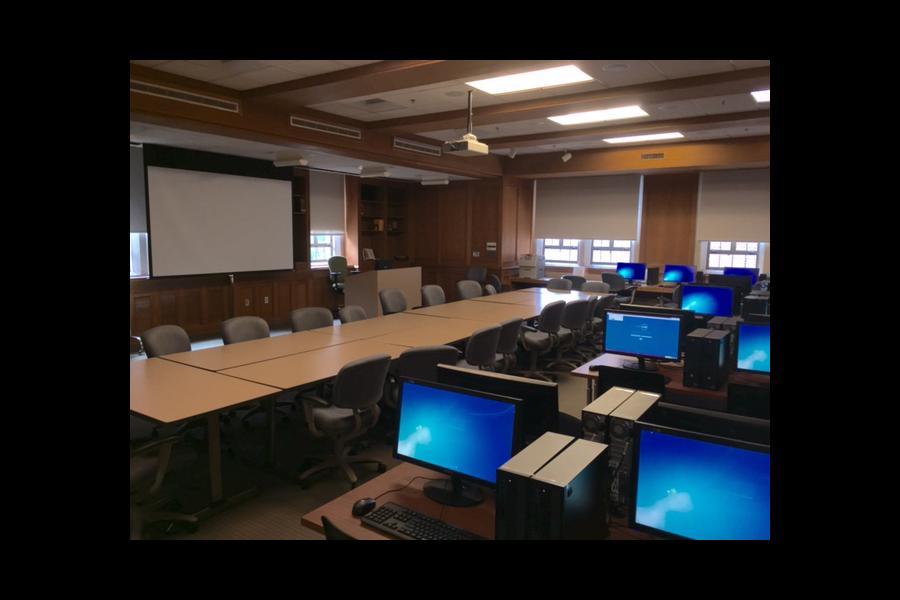 View of McCain 211 with computers, desks, and project screen